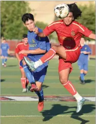  ?? RECORDER PHOTOS BY CHIEKO HARA ?? East's Moises Betencourt, left, takes a shot to score a goal as West's defender attempts to block it Saturday, June 23, during the East vs West game of the 10th annual Central Section Soccer All Star Game at Skadan Stadium in Lindsay.