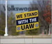  ?? OLIVIA ROSS — CHATTANOOG­A TIMES FREE PRESS VIA AP, FILE ?? A “We stand with the UAW” sign is placed outside of the Volkswagen plant in Chattanoog­a, Tenn., in 2023.