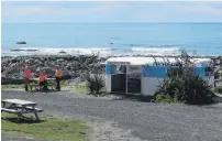  ??  ?? Friendly wave . . . Workers take a lunch break at Nin’s Bin.