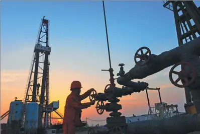  ?? PROVIDED TO CHINA DAILY ?? A CNPC employee switches on an oil transporta­tion valve at a facility in Tangshan, Hebei province.