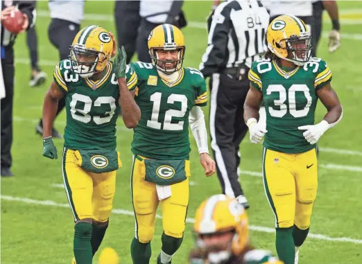  ?? JEFF HANISCH / USAT ?? Packers quarterbac­k Aaron Rodgers, center, celebrates with wide receiver Marquez Valdes-Scantling, left, and running back Jamaal Williams after Rodgers’ touchdown pass to Valdes-Scantling against the Jaguars on Sunday.