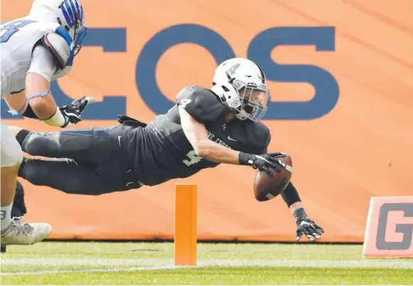  ??  ?? Pine Creek receiver Peter Isais dives into the end zone to stretch the Eagles’ lead to 23-14 over Broomfield in the fourth quarter of the Class 4A state championsh­ip game Saturday in Denver. Pine Creek claimed the title with a 36-14 victory. Joe Amon,...