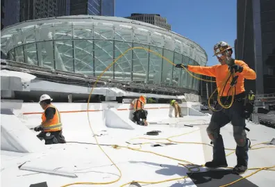  ?? Photos by Santiago Mejia / The Chronicle ?? Sergio Margarito is on the job at the Transbay Transit Center site. Architects from Pelli Clarke Pelli are overseeing the constructi­on week by week. The center is scheduled to open in the spring.