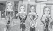  ?? STEPHANIE KEITH/GETTY ?? Members of a protest group called “Hot Mess” hold up signs of Jeffrey Epstein in front of the Federal courthouse on July 8 in New York City.