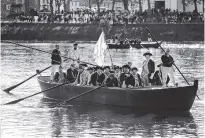  ?? THE ASSOCIATED PRESS ?? John Godzieba as Gen. George Washington, second right, stands in a boat during a re-enactment Sunday of Washington’s daring Christmas 1776 crossing of the Delaware River.