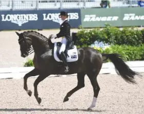  ??  ?? Australia’s Kristy Oatley rides the test of her life on Du Soleil, leading the class until the late stages and finally finishing 12th on 74.6%