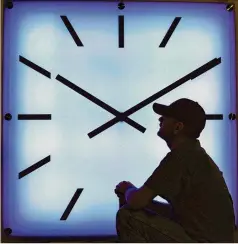  ?? ASSOCIATED PRESS ?? Electric Time Co. employee Dan Lamoore adjusts the color on a LED colorchang­ing clock at the plant in Medfield, Mass.