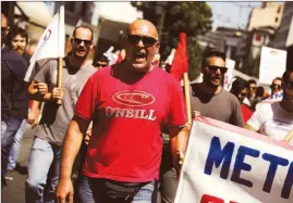  ??  ?? Members of the communist-affiliated Pame at a demonstrat­ion marking a 24-hour general strike against planned austerity measures in Athens on Wednesday