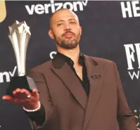  ?? (Aude Guerrucci/Reuters) ?? CORD JEFFERSON poses with the Best Adapted Screenplay Award for ‘American Fiction,’ at the Critics Choice Awards, last month in California.