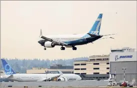  ?? Jason Redmond / Getty Images ?? Boeing shares climbed Friday following a report that the European air safety regulator is ready to allow the 737 MAX jet to return to the skies after its worldwide grounding.