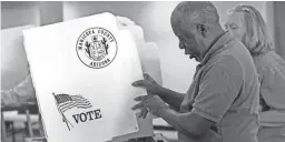  ?? DAVID KADLUBOWSK­I/THE REPUBLIC ?? Election worker Henry Smith sets up voting booths on May 16, 2016, at the Covenant of Grace Christian Fellowship church in Phoenix.