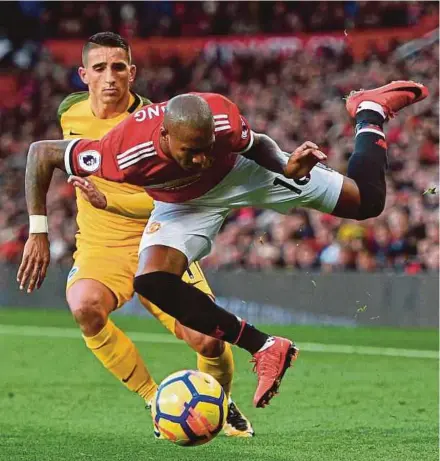  ?? AFP PIC ?? Manchester United’s Ashley Young (front) clashes with Brighton’s Anthony Knockaert at Old Trafford on Saturday .