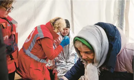  ?? LYNSEY ADDARIO/THE NEW YORK TIMES ?? An aid tent after an explosion at a residentia­l complex March 20 in Kyiv. Groups hope to prevent a public health disaster.