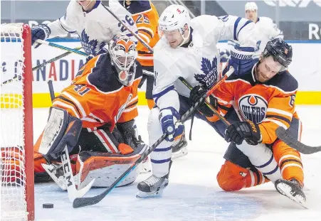  ?? JASON FRANSON, THE CANADIAN PRESS ?? Maple Leafs forward Zach Hyman puts the puck past Oilers goalie Mike Smith during the third period in Edmonton on Wednesday.