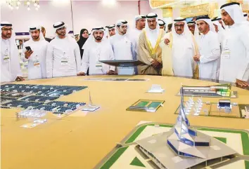  ?? Virendra Saklani/Gulf News ?? Shaikh Hamdan Bin Rashid takes studies a model of the Mohammad Bin Rashid Al Maktoum Solar Park after opening the 20th edition of Wetex 2018 in Dubai yesterday.