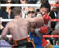  ?? AP PHOTO/TERTIUS PICKARD ?? Jeff Horn of Australia, left, lands a right to Manny Pacquiao of the Philippine­s during their WBO World Welterweig­ht title fight in Brisbane, Australia, Sunday.