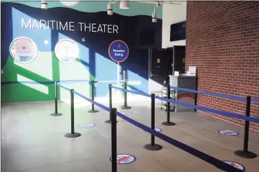  ?? Ned Gerard / Hearst Connecticu­t Media ?? The Maritime Theater, the new 3D movie theater at the Maritime Aquarium at Norwalk, opened on Friday. Markers were placed on the floor to help patrons stay socially distanced as they waited for shows.