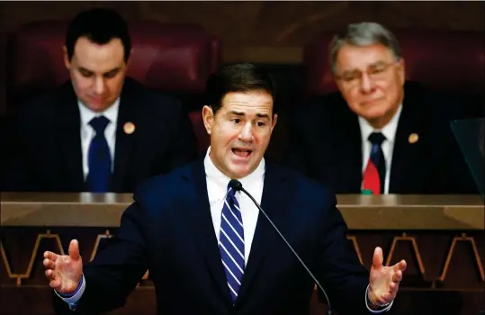  ?? ASSOCIATED PRESS PHOTOS ?? ARIZONA REPUBLICAN GOV. DOUG DUCEY GIVES HIS STATE OF THE STATE ADDRESS AS HE IS FLANKED by House Speaker J.D. Mesnard (left), R-Chandler, and Senate President Steve Yarbrough (right), R-Chandler, at the capitol on Monday in Phoenix.