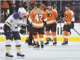  ?? AP PHOTO ?? ORANGE CRUSH: The Flyers celebrate a goal by Sean Couturier (second from right) during yesterday’s win against the Blues.