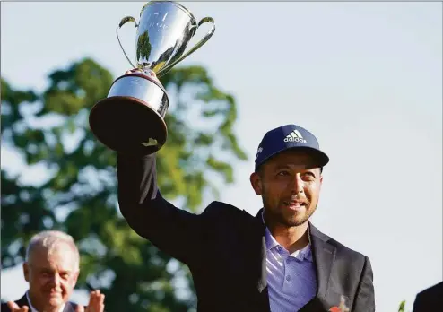  ?? Seth Wenig / Associated Press ?? Xander Schauffele holds the trophy after winning the Travelers Championsh­ip at TPC River Highlands Sunday in Cromwell.