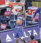  ?? Wendell Cruz / Associated Press ?? Knicks guard RJ Barrett dunks in the second quarter Saturday. New York shot 52 percent in the win.