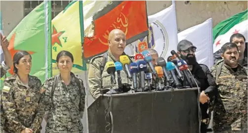  ??  ?? HAZIMA, Syria: Talal Sello (center) spokesman for the US-backed Syrian Democratic Forces (SDF) gives a speech as SDF commander Rojda Felat (second left) and other fighters listen on in this village on the northern outskirts of the Islamic States (IS)...