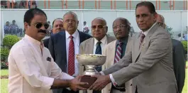  ?? — ASIAN AGE ?? Hyderabad Race Club steward N. Vishnu Vardhan Reddy ( right) presents the Darley Arabian Million trophy to K. Thribhuvan Reddy after City of Harmony won the main event of the races held in Hyderabad on Monday.