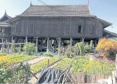  ??  ?? This teakwood house is the original style of Tai Leu’s home. It belongs to Muang-in Saiwangjit. The house has 40 pillars and was built in 1951. It has only one big room, which is a shared bedroom for his family members. Muang-in also has his own...