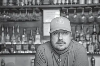  ??  ?? Todd Scott poses behind a bar in Porterdale, Ga.. on June 1, 2016. Americans' views are starkly different, underscori­ng the ever-widening divide over gun rights. [LISA MARIE PANE/ THE ASSOCIATED PRESS]