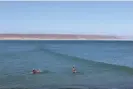  ?? Laura Paddison ?? Surfers at San Juanico, which boasts one of the world’s longest waves. Photograph: