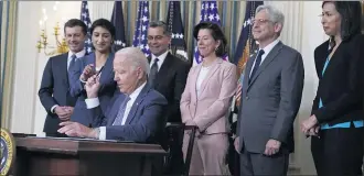  ?? EVAN VUCCI — THE ASSOCIATED PRESS ?? President Joe Biden hands out a pen after signing an executive order aimed at promoting competitio­n in the economy, in the State Dining Room of the White House, on July 9.