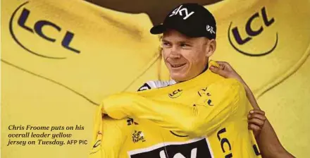  ?? AFP PIC ?? Chris Froome puts on his overall leader yellow jersey on Tuesday.