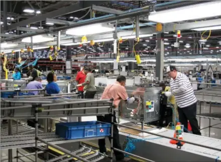  ?? FILE PHOTOS - ASSOCIATED PRESS ?? The manufactur­ing sector in the region is enjoying better results, according to a recent survey, but employers are finding it difficult to recruit all the workers they need.