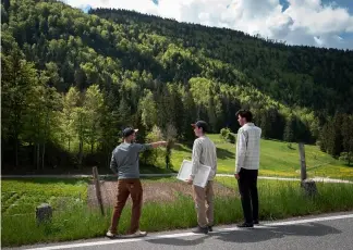  ?? ?? The Gyger brothers (From L) Gaetan, Tim and Luca of Gagygnole distillery stand on the way to collect sweet woodruff in a forest near Souboz Fabrice Coffrrini/AFP