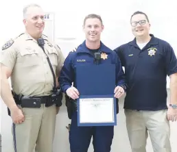  ?? Appeal-democrat ?? From left to right, CHP Lieutenant Doug Ferguson, CHP Officer Ray Close and CHP Assistant Chief Rob Krider pose for a photo after Close was presented a commendati­on for pulling a woman to safety.