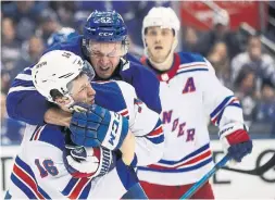  ?? STEVE RUSSELL TORONTO STAR ?? Toronto Maple Leafs defenceman Martin Marincin, centre, scuffles with the New York Rangers’ Ryan Strome after a whistle at Scotiabank Arena on Saturday. Marincin will be line for a regular role with all of the Leafs’ injuries.