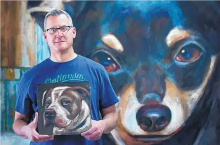  ?? EDDIE MOORE/JOURNAL ?? Artist Mark Barone stands in front of his 8-foot-by-8-foot portrait of Tiny Totts, a Chihuahua that was euthanized. It is one of 5,500 dog paintings that Barone says he has created, almost all of them on 12-inch-by-12 inch panels.