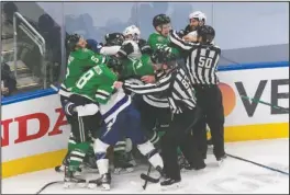  ?? The Associated Press ?? NOT LOOKING GOOD: Dallas Stars and Tampa Bay Lightning players fight Wednesday during the third period of Game 3 of the NHL Stanley Cup Final in Edmonton, Alberta.