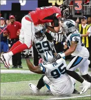  ?? CURTIS COMPTON / CCOMPTON@AJC.COM ?? Matt Ryan scores the game-winning touchdown on a quarterbac­k keeper in the fourth quarter against the Panthers on Sunday.