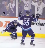  ?? TREVOR HAGAN/ASSOCIATED PRESS ?? Winnipeg’s Blake Wheeler, left, celebrates with teammate Mark Scheifele after scoring with 4:59 left in the third period to break a 4-4 tie in the Jets’ comeback victory over Nashville on Tuesday night.
