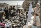  ?? SERGEY PONOMAREV — THE NEW YORK TIMES ?? Earthquake survivors pick from donated clothes in Antakya, Turkey, on Thursday.