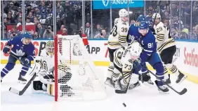  ?? RICHARD LAUTENS TORONTO STAR ?? Maple Leafs centre John Tavares, separated from the puck by Bruins defenceman Charlie McAvoy, was held off the scoresheet in Saturday night’s Game 4 at Scotiabank Arena.