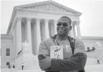  ?? Tribune News Service ?? Bryant Johnson, personal trainer for Supreme Court Justice Ruth Bader Ginsburg, poses in Washington with his new book, "The RBG Workout: How She Stays Strong ... and You Can Too!" Besides the 84-year-old Ginsberg, Johnson now also trains Justice...