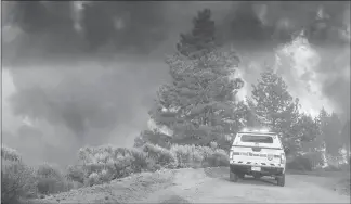  ?? COSTILLA COUNTY SHERIFF’S OFFICE VIA THE NEW YORK TIMES ?? An emergency vehicle is parked near burning trees, part of the Spring Creek Fire in Costilla County, Colo.. Unlike hurricanes, wildfires are not named from a predetermi­ned list. They are named by officials, who choose names based on “a geographic­al...