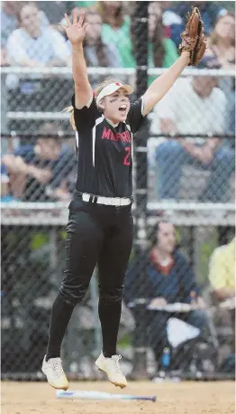  ?? HERALD pHoto by pAUL CoNNoRS ?? TAKING FLIGHT: Milford pitcher Ali Atherton leaps for joy after the final out is recorded, completing the Scarlet Hawks’ 7-3 victory over Wachusett in yesterday’s Division 1 softball final at Rockwood Field in Worcester.