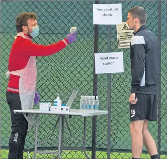  ??  ?? St Mirren’s Jack Baird has his temperatur­e checked at training