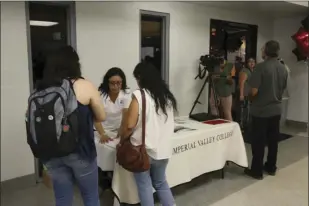  ??  ?? ABOVE: Students get help during a “one-stop” service event during the first week of classes at Imperial Valley College.
LEFT: Students work their way from table to table to get them ready for the beginning of the fall semester during a “one-stop”...