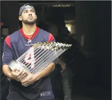  ?? Yi-Chin Lee / Houston Chronicle ?? The Astros’ George Springer holds the World Series trophy while waiting in the tunnel to be recognized during the first quarter of a game between the Houston Texans and Indianapol­is Colts on Nov. 5.