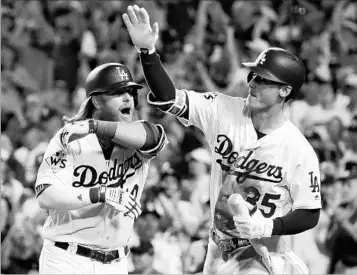  ?? MATT SLOCUM/AP ?? Justin Turner, left, celebrates his two-run homer with Cody Bellinger during the sixth inning of Tuesday night’s game.