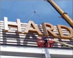  ?? THE ASSOCIATED PRESS ?? Part of the first sign for the soonto-open Hard Rock Casino in Atlantic City N.J., is lifted into place on the building.